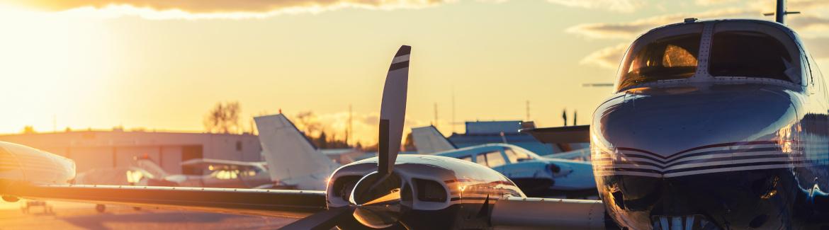 private jet is parked on tarmac at sunset